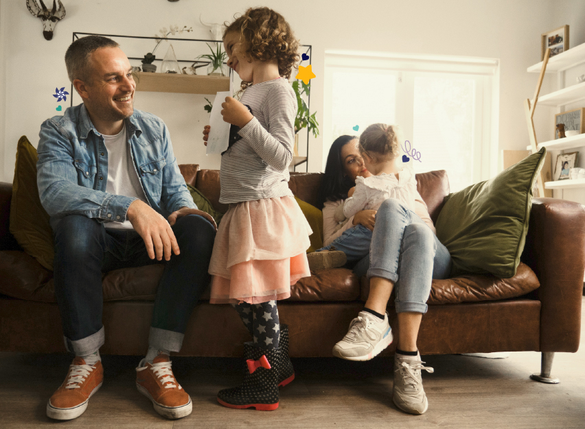 Parents talking and playing with their children in the living room